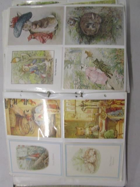 Two albums of mixed postcards to include Beatrix Potter, The Flintstones, topographical and