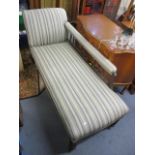 A late Victorian/Edwardian mahogany chaise longue having spindle back supports and turned legs