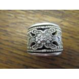 A contemporary Chinese white metal thumb ring, flower and leaf decoration, moveable outer layer,