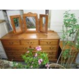 A contemporary pine dressing chest of three short drawers over three rows of two longer drawers on