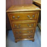 A reproduction bedside yew chest with four small drawers, on bracket feet, 26" x 16" x 13"