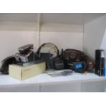 A mixed lot of electrical items to include a phone, a walkie talkie and a Polaroid land camera