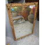 A 20th century pine carved framed mirror 39" x 27"