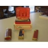 A set of four lighters to include Colibri, Mulberry and Dunhill