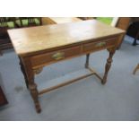 An early 20th century oak two drawer side table, on turned, carved block legs, 30" x 42" x 20"