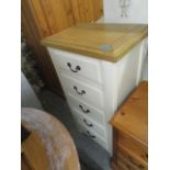 A cream painted and light wood tall chest of five drawers, 48" x 25 6/8" x 16"