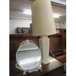 A white painted pottery table lamp decorated in the Japanese style with warriors, cranes and