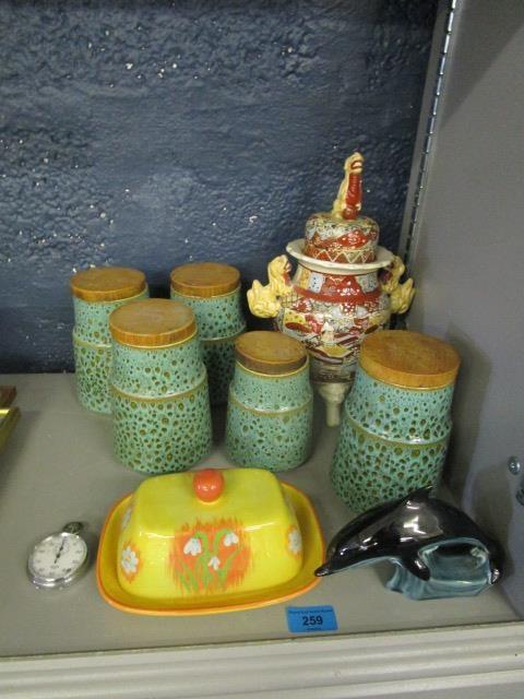 A group of ceramics to include Poole storage jars, a Japanese Satsuma pot and cover, a Poole dolphin