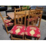 An oak dining table with scrolled supports with six matching Medieval style dining chairs and two