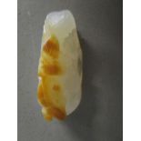 A modern Chinese carved white hardstone pendant with brown inclusion, carved leaf and fruit