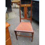 An Arts & Crafts mahogany and marquetry splat back chair on square legs