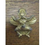 A reproduction gilt brass Tibetan plaque, 3 3/4"long