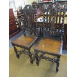 A pair of 19th century carved dining chairs with barley twist supports