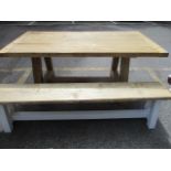A pine plank constructed trestle style kitchen table with one matching bench originally purchased