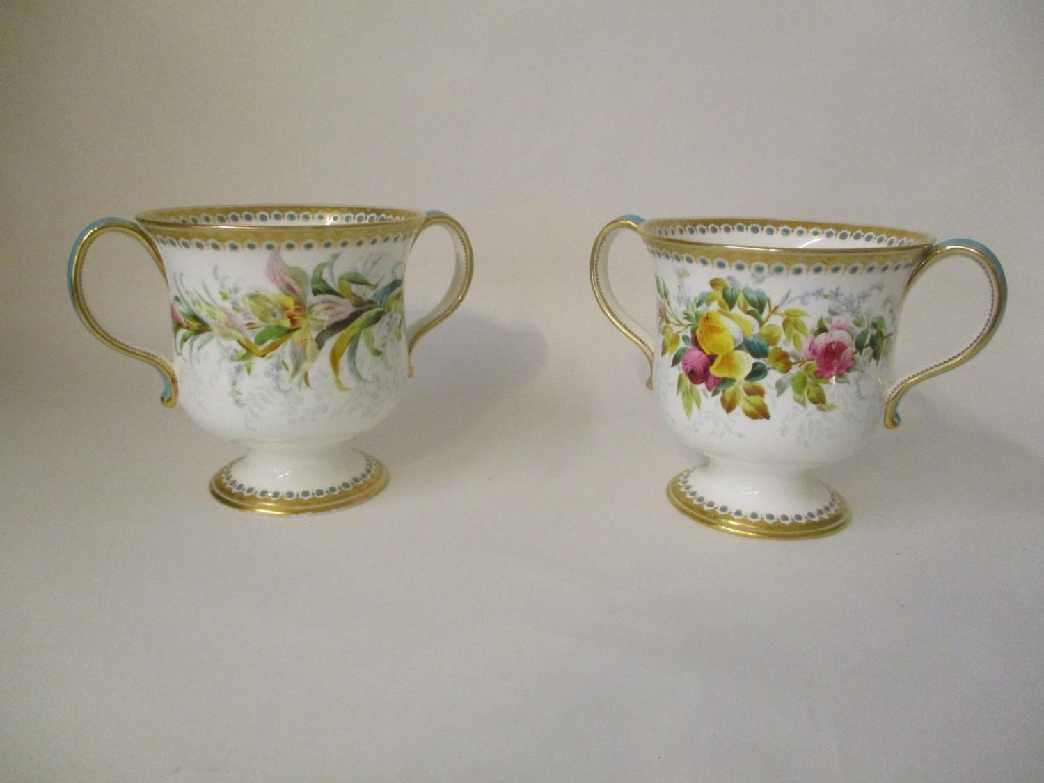 A pair of early 20th century English porcelain twin handled cups, on a splayed foot decorated with - Image 2 of 2