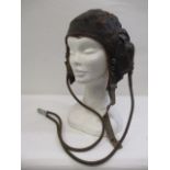 A WWII brown leather flying helmet with earphones, inscribed Ref NO 6F/154 AM