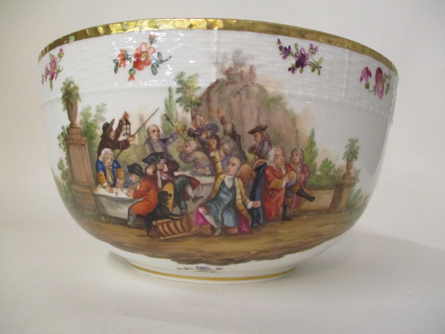 A late 19th century KPM porcelain bowl decorated with a group of men around a table in a garden