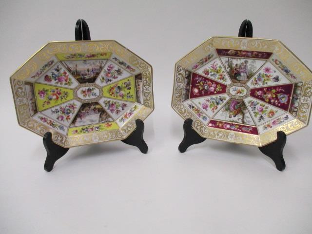 A pair of 19th century KPM octagonal dishes, decorated with panels of harbour scenes and flowers