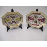 A pair of 19th century KPM octagonal dishes, decorated with panels of harbour scenes and flowers