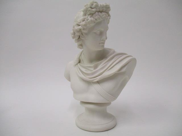 A 19th century Parian ware bust of a classical man wearing a sash, on a sockel, 11"h