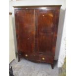 A 19th century mahogany wardrobe with a pair of doors over a long drawer, on splayed, bracket feet