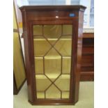 An early 19th century mahogany corner cabinet with an astrigal glazed door, 42" h, 26"w