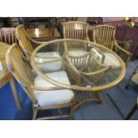 A conservatory glass topped, circular dining table and four chairs, 29"h x 47"w