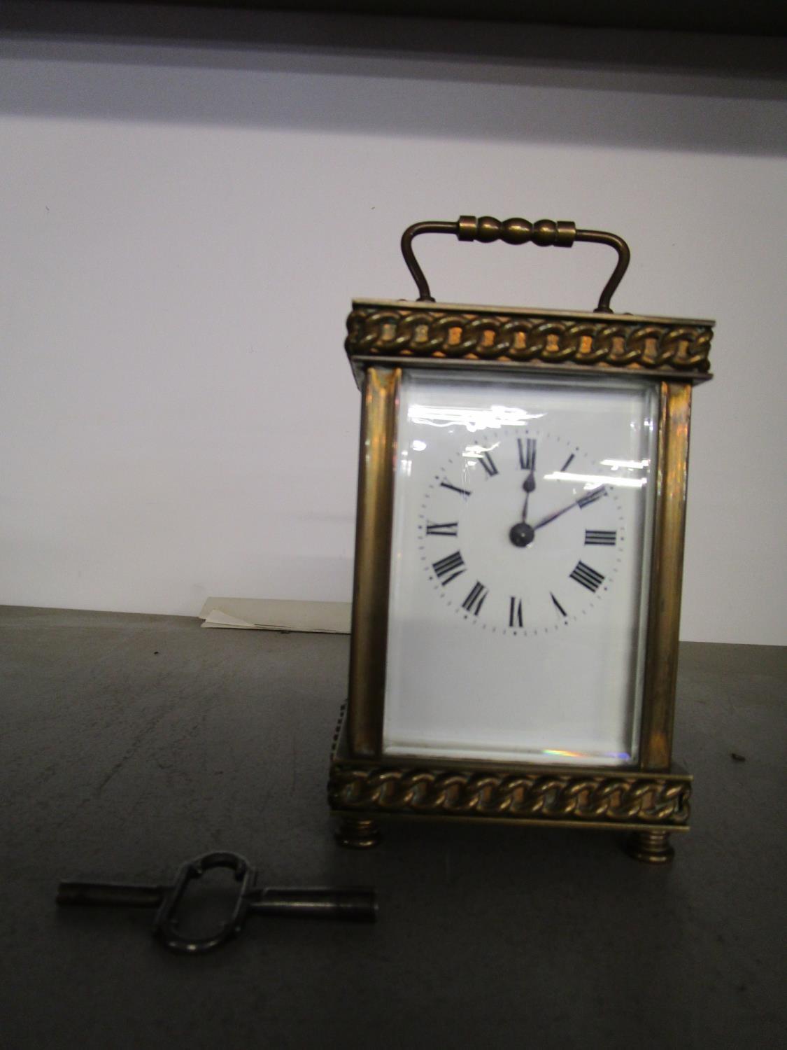 A French brass cased five window carriage clock, with key