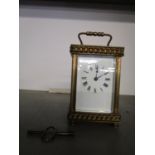 A French brass cased five window carriage clock, with key