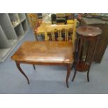 An Edwardian inlaid mahogany, two tier plant stand and a quarter veneered walnut table on carved