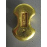 A modern Chinese gilt metal trading token, stamped Chinese characters to the top, together with