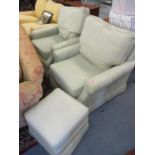 A pair of modern Wesley & Barrell armchairs with matching footstools