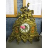 A French gilt metal mantle clock having marble plaques depicting a man riding a horse on finial