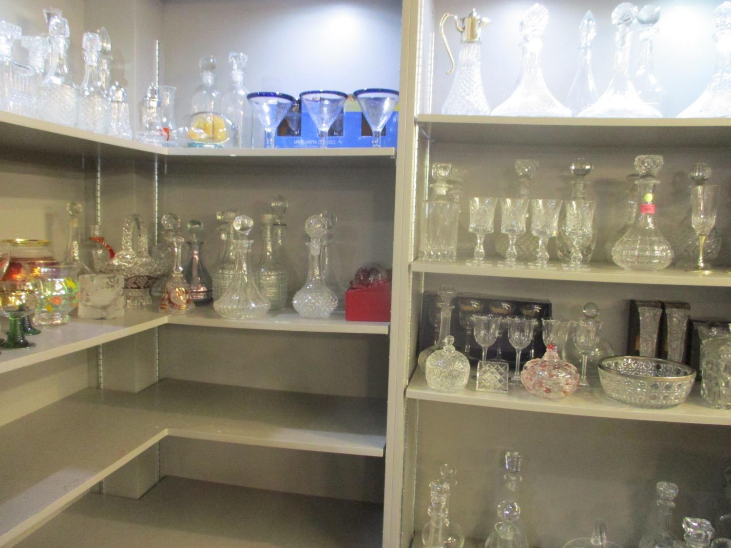 A large selection of glassware to include forty four decanters, hand blown glasses, wine glasses,