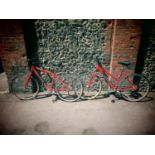 A Cannondale SP300 red coloured bike and a matching ladies bike with owners manual