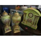 A late 19th/early 20th century porcelain painted mantel clock and a pair of matching vases A/F