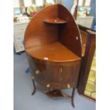 A Georgian mahogany corner wash stand having a single door and drawer, standing on three splayed