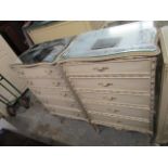 A pair of cream painted chests of five graduated drawers on leaf decorated splayed legs 44 1/4" x 25