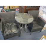 A pair of modern garden armchairs, together with a matching circular occasional table