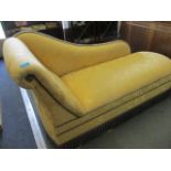 A modern chaise longue upholstered in a yellow floral fabric with blue piping 27" x 58" x 21"