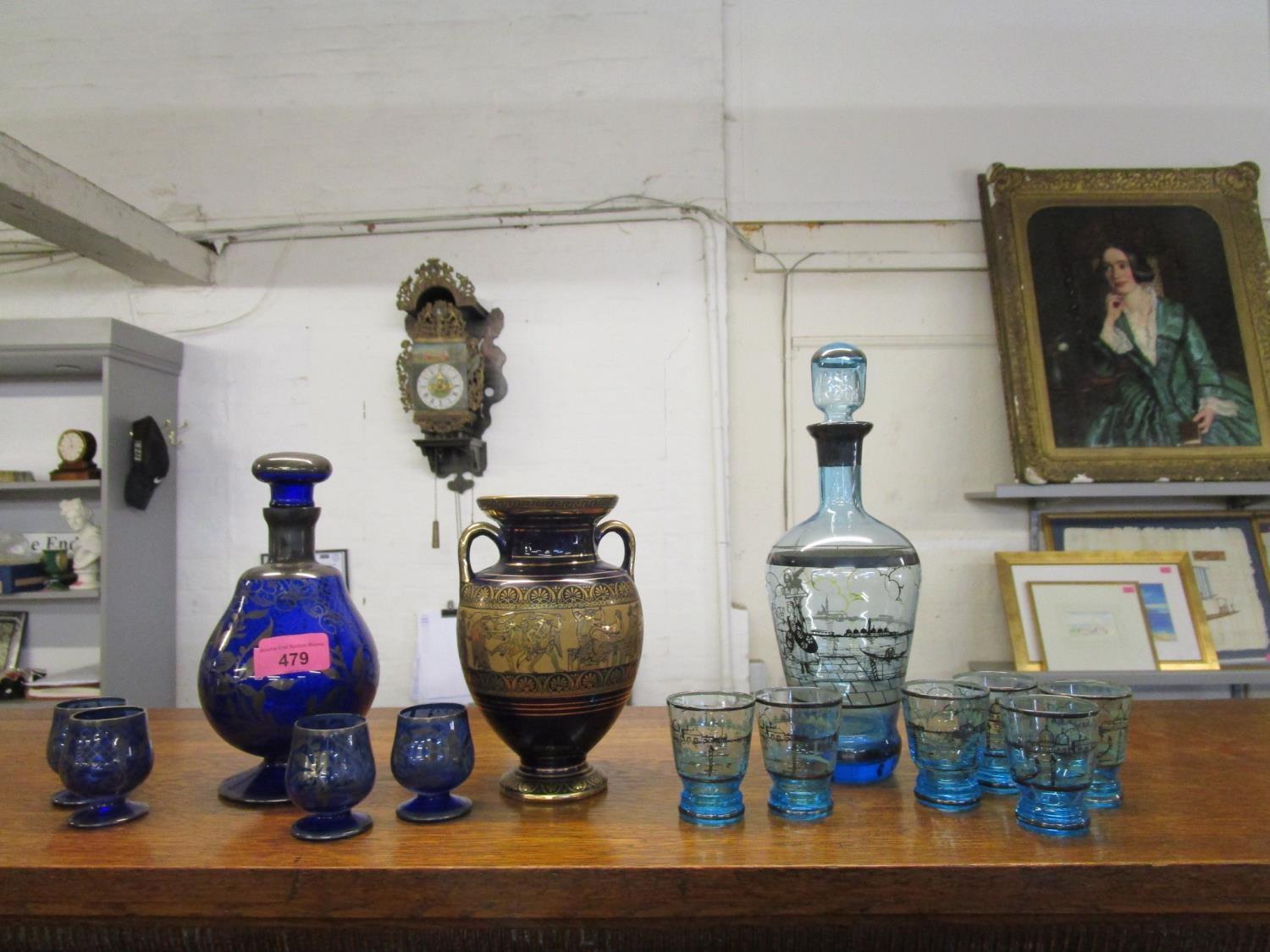 Two Venetian glass decanter sets, one with four glasses and the other six, along with a Greek vase