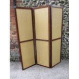 A mahogany framed three fold screen with rattan weave inset panels