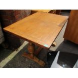 An oak extending dining table with leaves and bulbous supports 29 1/2"h x 42"w