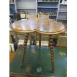 An early 20th century walnut finished occasional table having a three leaf clover design and