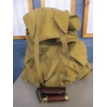 A military canvas rucksack with a wire frame and a Tasco pocket telescope