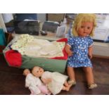 Three dolls to include a Rosebud doll, together with mixed dolls clothing