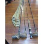A vintage R C Moore fishing rod and three vintage golf drivers