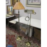 A brass standard lamp with a reeded column on a square base and a height adjustable brass reading