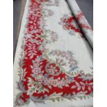 A large Indian cream and red ground rug 300cm x 270cm