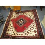 A hand woven Persian Kalardash rug, geometric and floral decoration on a white and red ground,